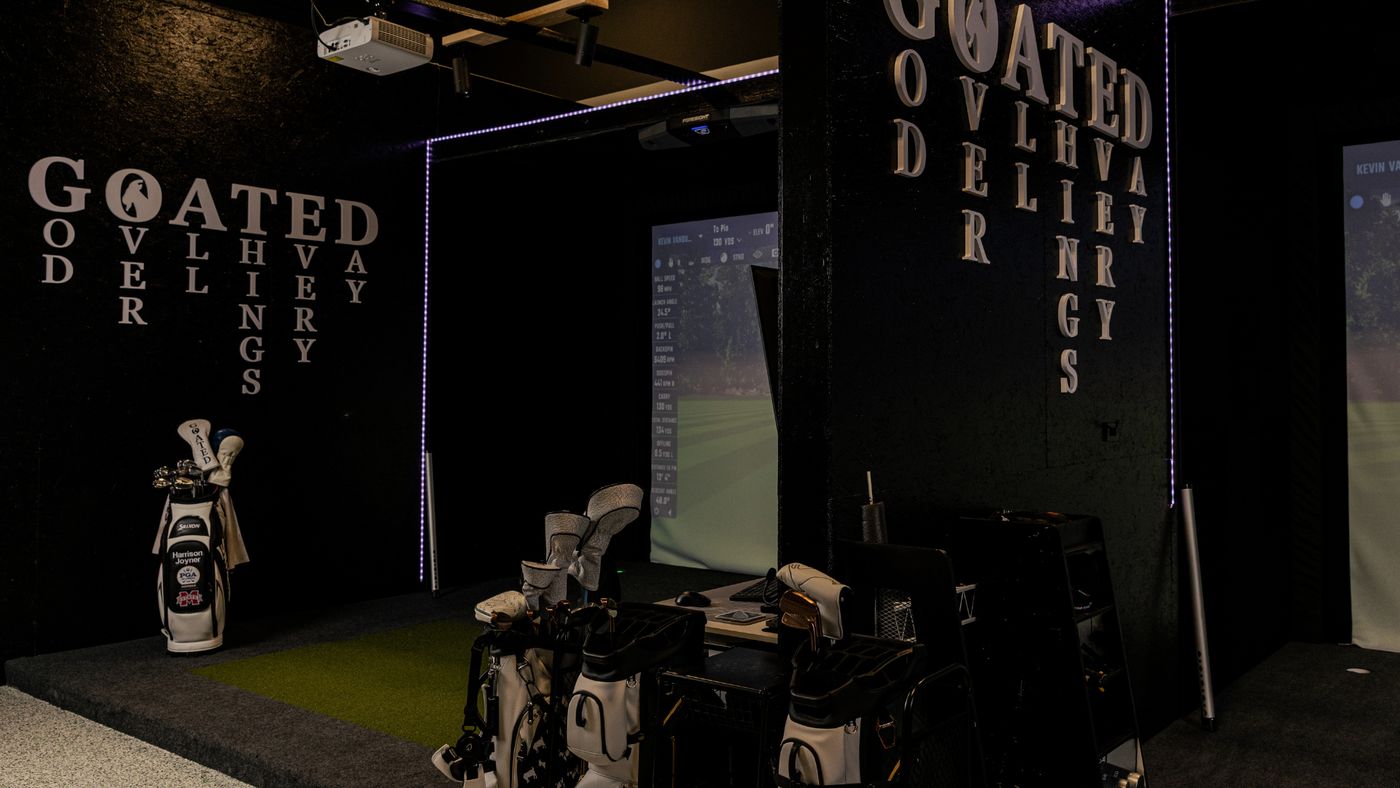 Inside the GOATED Clubhouse: simulator bays with Foresight launch monitors and GOATED wall lettering