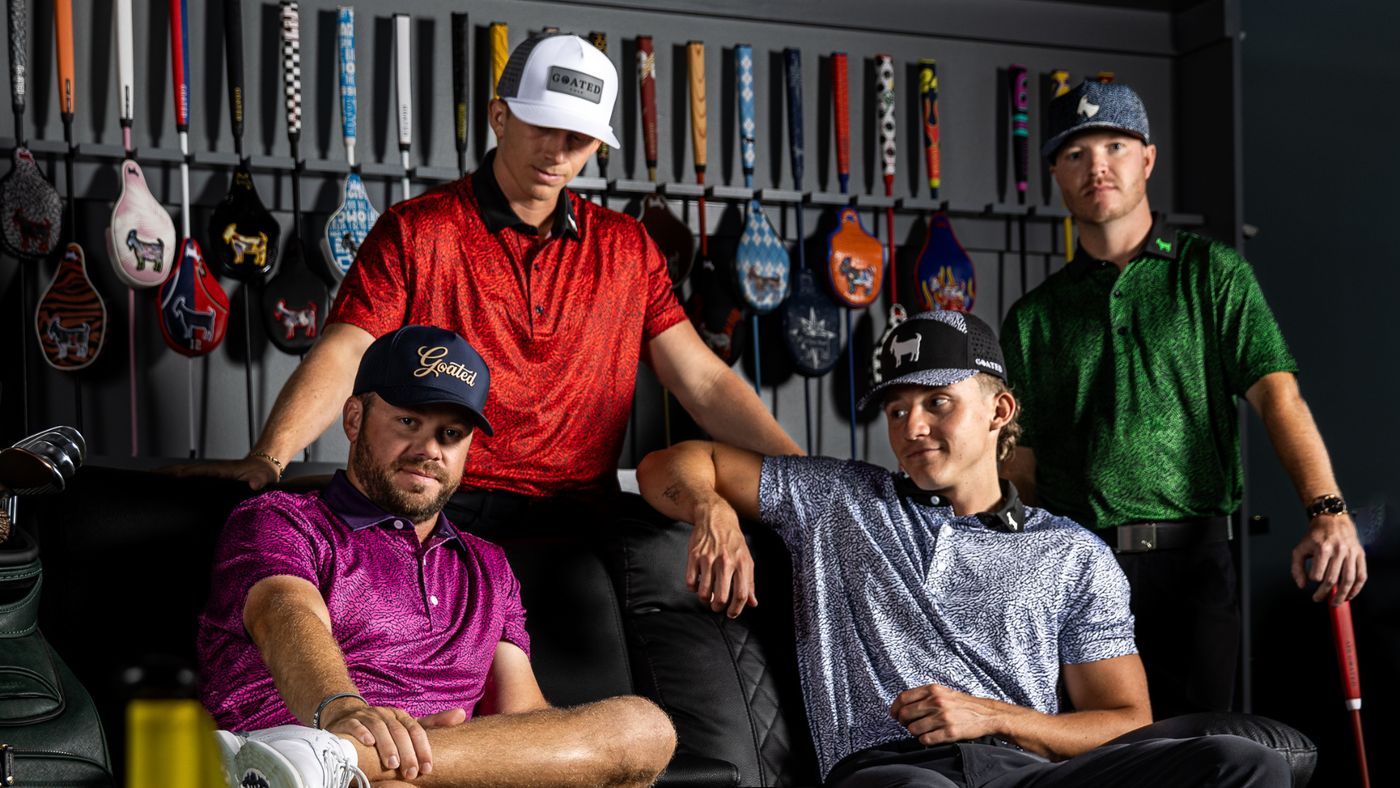 GOATED Golf team members in GOATED polos and hats in front of the putter wall